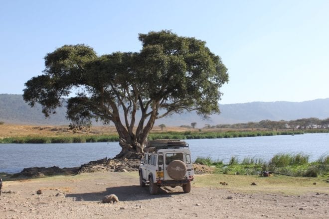 author’s car parked by a lake on safari in East Africa